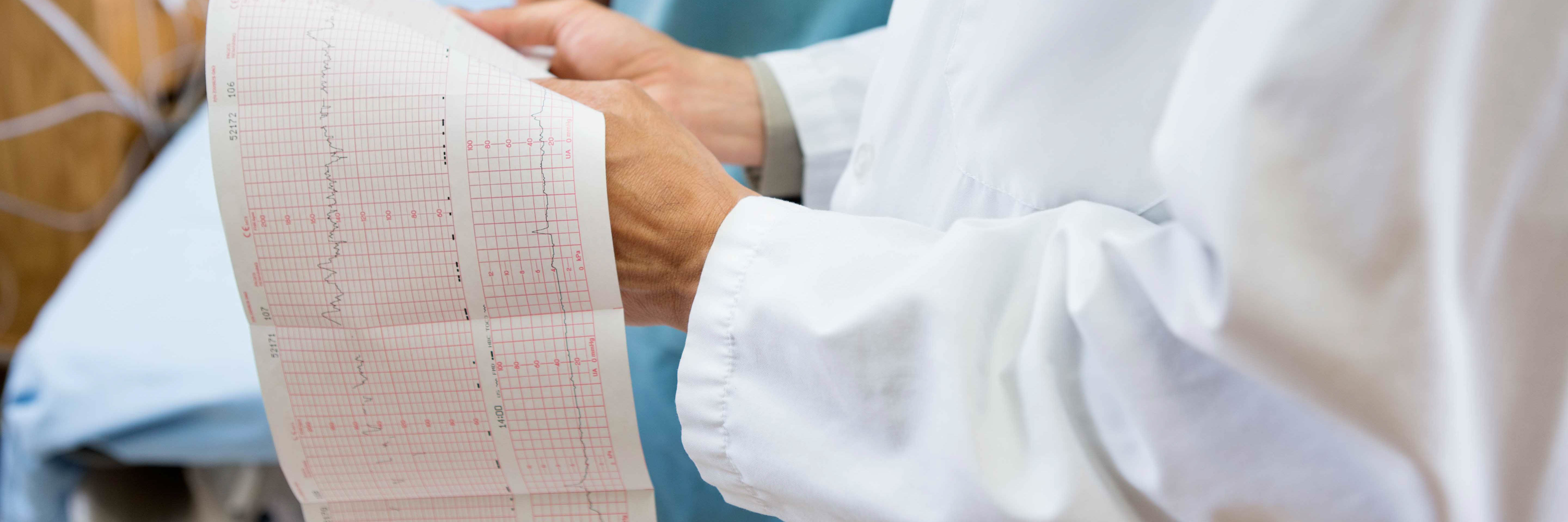 A healthcare provider holding a medical chart.